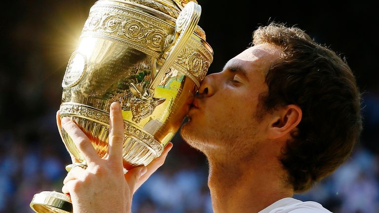 Andy Murray of Britain poses with the trophy after defeating Novak Djokovic of Serbia during the Men's singles final match at the All England Lawn Tennis Championships in Wimbledon, London, Sunday, July 7, 2013. (AP Photo/Kirsty Wigglesworth) 