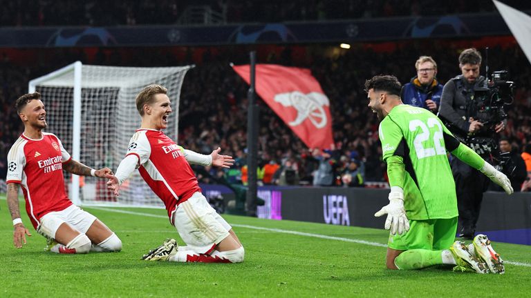 Martin Odegaard and Ben White celebrate with David Raya after the latter's penalty heroics