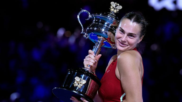 Belarus' Aryna Sabalenka holds the Daphne Akhurst Memorial Cup after defeating China's Zheng Qinwen in the women's singles final at the Australian Open