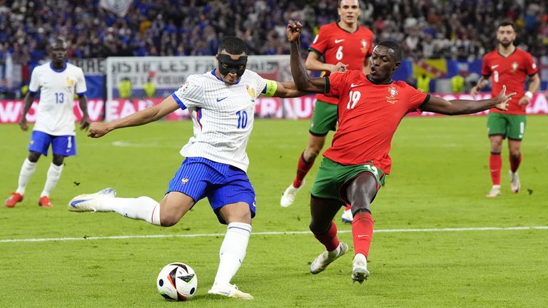 Kylian Mbappe looks to get a shot away against Portugal