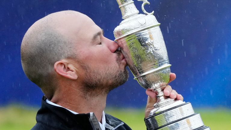 United States' Brian Harman poses for the media as he holds the Claret Jug trophy for winning the British Open Golf Championships at the Royal Liverpool Golf Club in Hoylake, England, Sunday, July 23, 2023. (AP Photo/Jon Super)